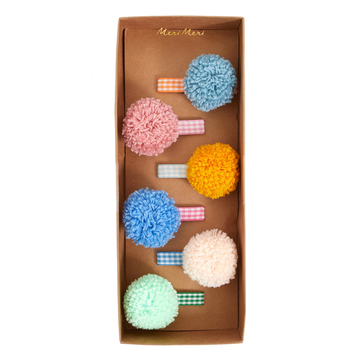 Meri Meri pom-pom hair clips packaged in a presentation box with gingham ribbon bases.