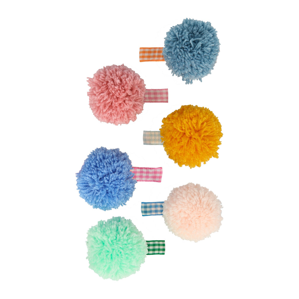 A set featuring playful fabric-covered clips with bright gingham patterns and oversized pom poms—perfect for fun, stylish accessorizing.