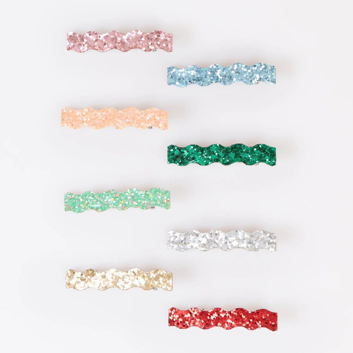 Eight wavy glitter hair clips in various colors arranged against a white background.