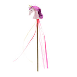 Pink glittery unicorn wand with a gold stick and hanging pink ribbons, isolated on a white background.
