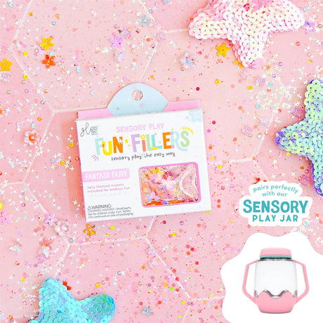 Glo Pals Fantasy Fairy Fun Fillers box on a pink glittery background with floral trinkets and sequins.