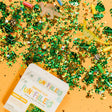 Glo Pals Sensory Safari Fun Fillers box on a yellow background with green leaf confetti and animal trinkets.