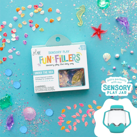 Glo Pals Under the Sea Fun Fillers pack surrounded by ocean-themed trinkets, glitter, and tiny plastic shells.
