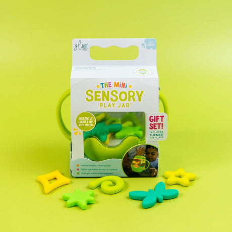 Glo Pals Mini Sensory Play Jar box set with green handles and colorful fillers on a green background.