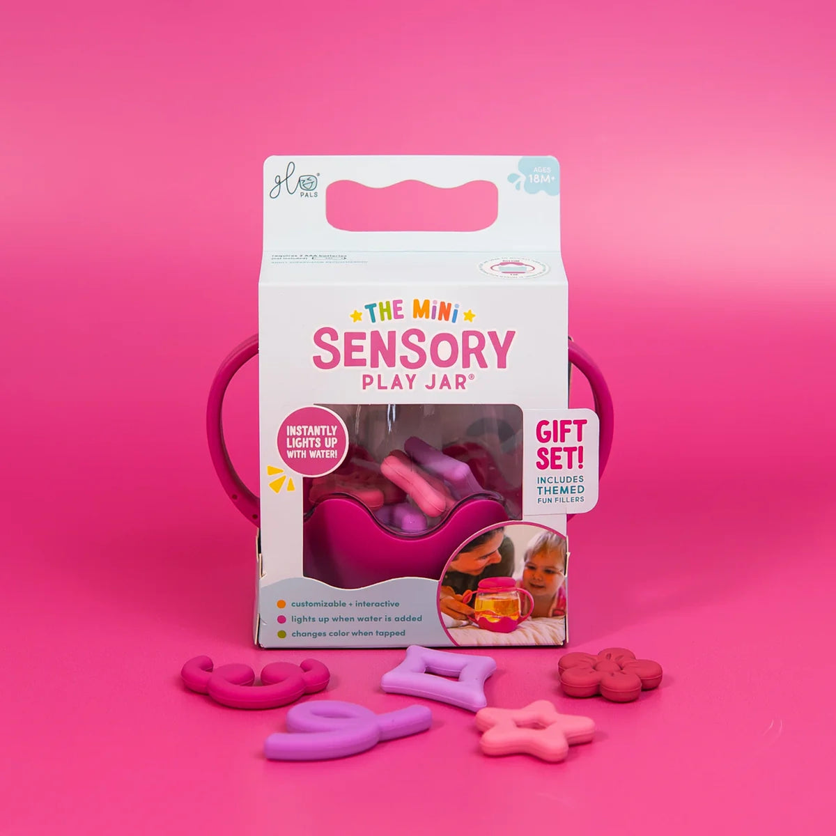 Packaging for Glo Pals Mini Sensory Play Jar in pink, with themed silicone fillers spread in front.