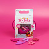 Packaging for Glo Pals Mini Sensory Play Jar in pink, with themed silicone fillers spread in front.