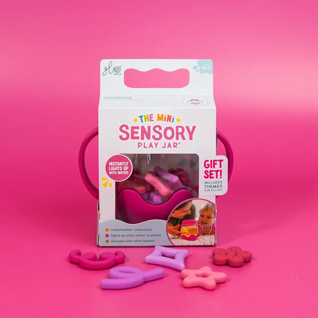 Packaging for Glo Pals Mini Sensory Play Jar in pink, with themed silicone fillers spread in front.
