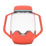 Clear plastic sensory jar with coral-red handles, lid, and base against a plain white background.