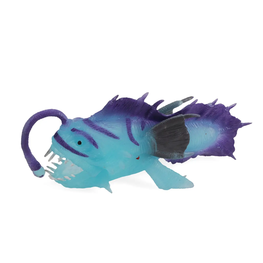 Toy anglerfish in shades of blue and purple with detailed fins and a glowing lure, displaying a playful yet eerie underwater creature design.