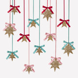 Gold glitter star hanging decorations featuring satin ribbons and bows in shades of red, light pink, and mint green.