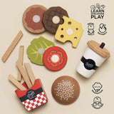 Wooden fast food toy set with burger parts, fries in a holder, and a soda cup, promoting learning and play.
