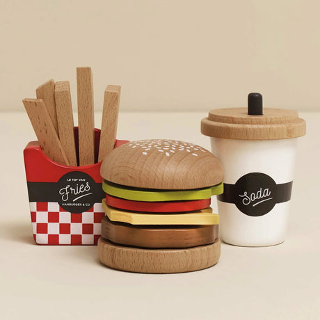 Wooden toy set with a burger, a red holder with wooden fries, and a white cup labeled Soda.