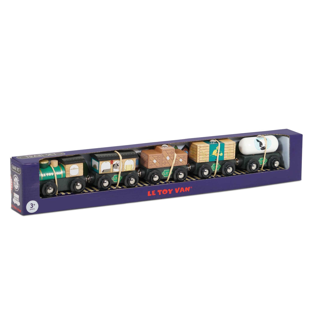Toy train set box with colorful wooden train cars featuring various designs, including cargo and a milk tanker. Box labeled "Le Toy Van," suitable for ages 3+.