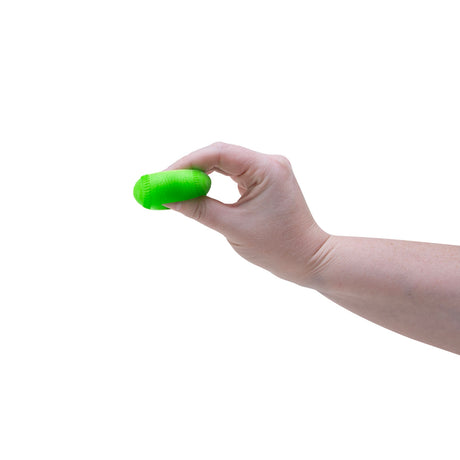 Hand squeezing a green Teenie NeeDoh Hot Shot squishy baseball toy to demonstrate its soft, flexible texture.
