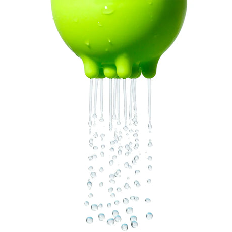 Green Plui rainball bath toy by Moluk releasing streams of water against a clean white background.