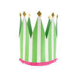 Green and white striped paper party crown with gold glitter tips and pink fringe detail on a white background.