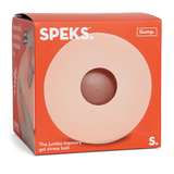 Box for a Speks jumbo memory gel stress ball with a red-orange design. The front shows a circular tan ball with a central indentation, exuding a calming vibe.