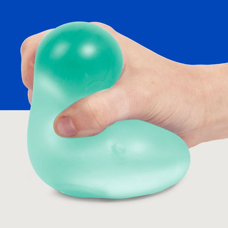 A hand squeezes a teal stress ball against a two-tone blue and white background, conveying a sense of relaxation and tension relief.