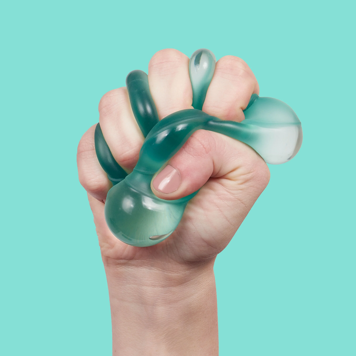 A hand tightly squeezes a translucent, teal stress ball with tentacle-like extensions, set against a bright turquoise background, conveying tension.