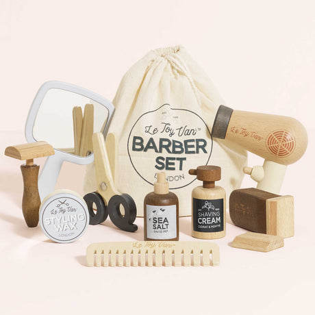 Wooden barber kit with play tools, hair products, mirror, and a Le Toy Van drawstring storage bag.