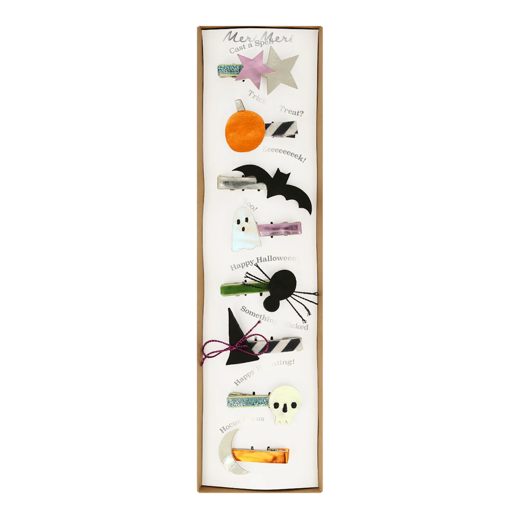 A vertical display of Halloween-themed hair clips, featuring stars, a pumpkin, bat, ghost, spider, witch hat, skull, and crescent moon on a white background.