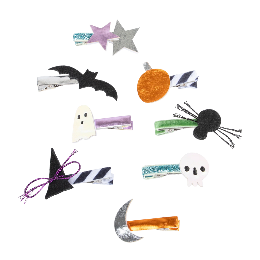 Nine Halloween-themed hair clips arranged on a white background, featuring stars, a bat, ghost, pumpkin, cat, witch hat, skull, and moon designs.