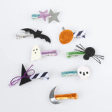 Set of Halloween hair clips featuring a bat, ghost, pumpkin, witch hat, spider, skull, and moon.