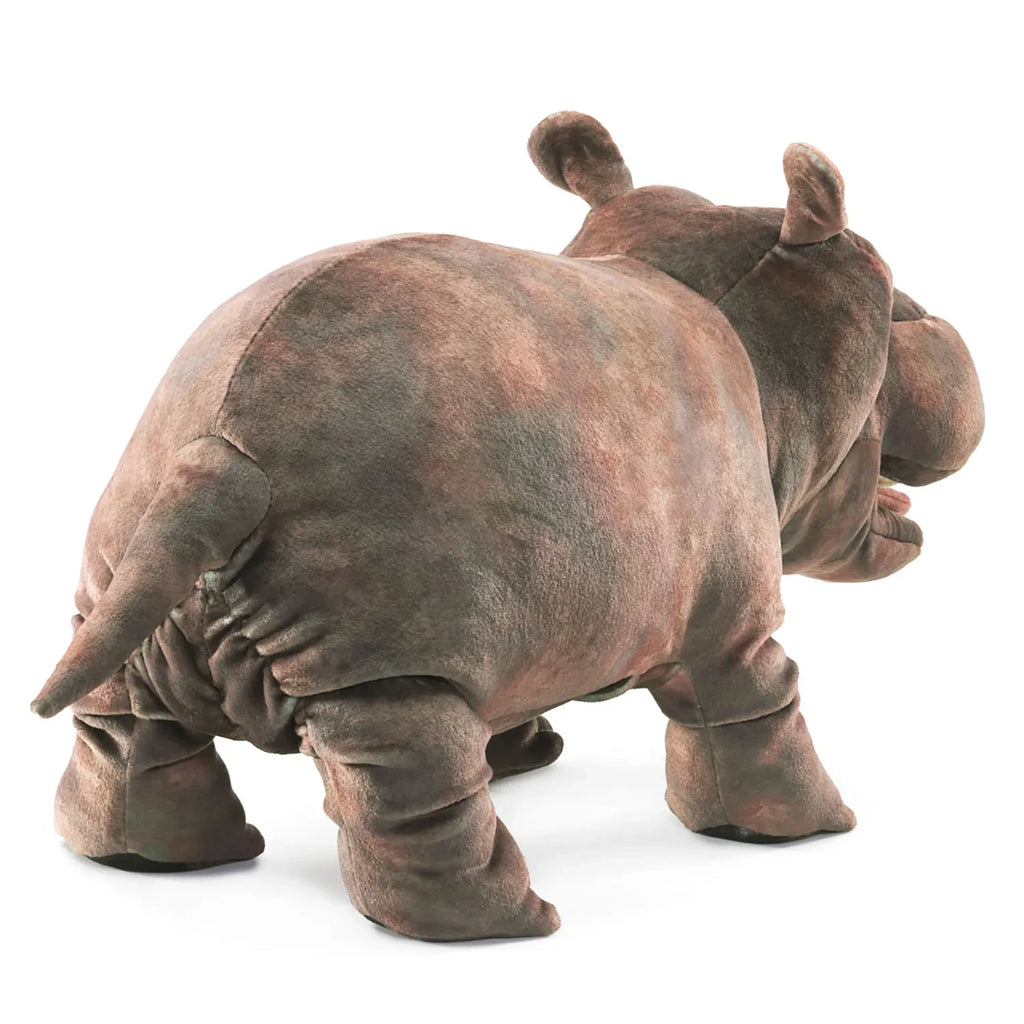 A plush hippo toy viewed from the back, showcasing its round body, short legs, and small tail. The texture is soft, conveying a playful, cozy feeling.