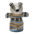A knitted badger puppet wearing a cozy, patterned sweater in beige, blue, and black. It has a friendly expression and is set against a white background.