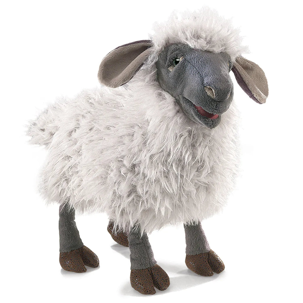 Fluffy sheep plush toy with a soft, woolly body and gray face. It has floppy ears, dark hooves, and a friendly, smiling expression.