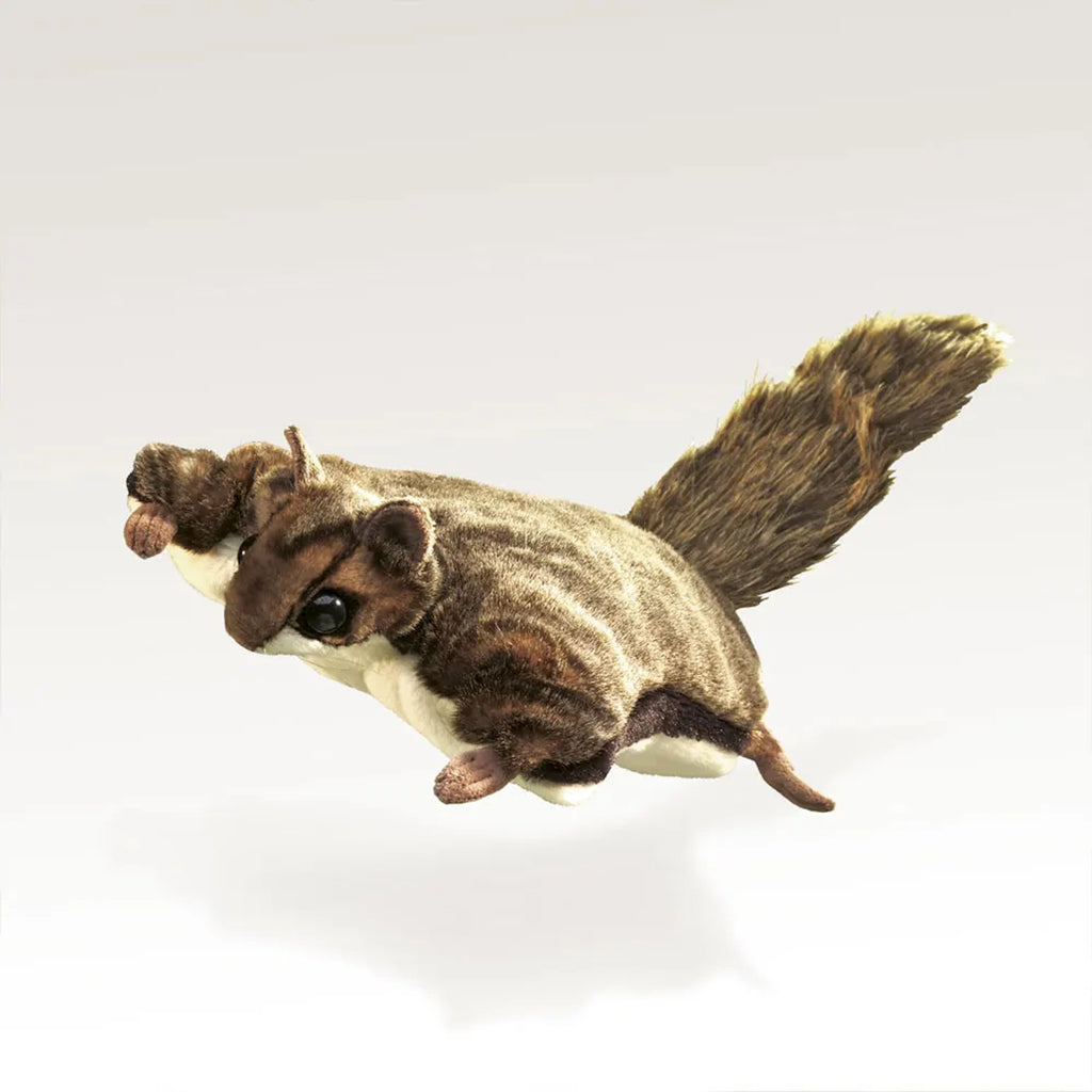 Plush flying squirrel toy with a fluffy tail and detailed facial features against a plain background, conveying a sense of fun and whimsy.