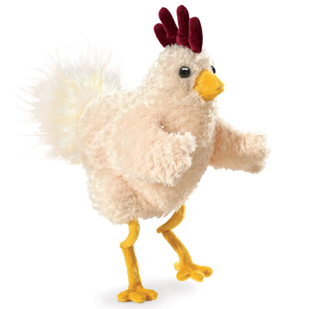 Fluffy toy chicken with a cream body and yellow legs. It has a red comb and a yellow beak, conveying a playful and cheerful tone.