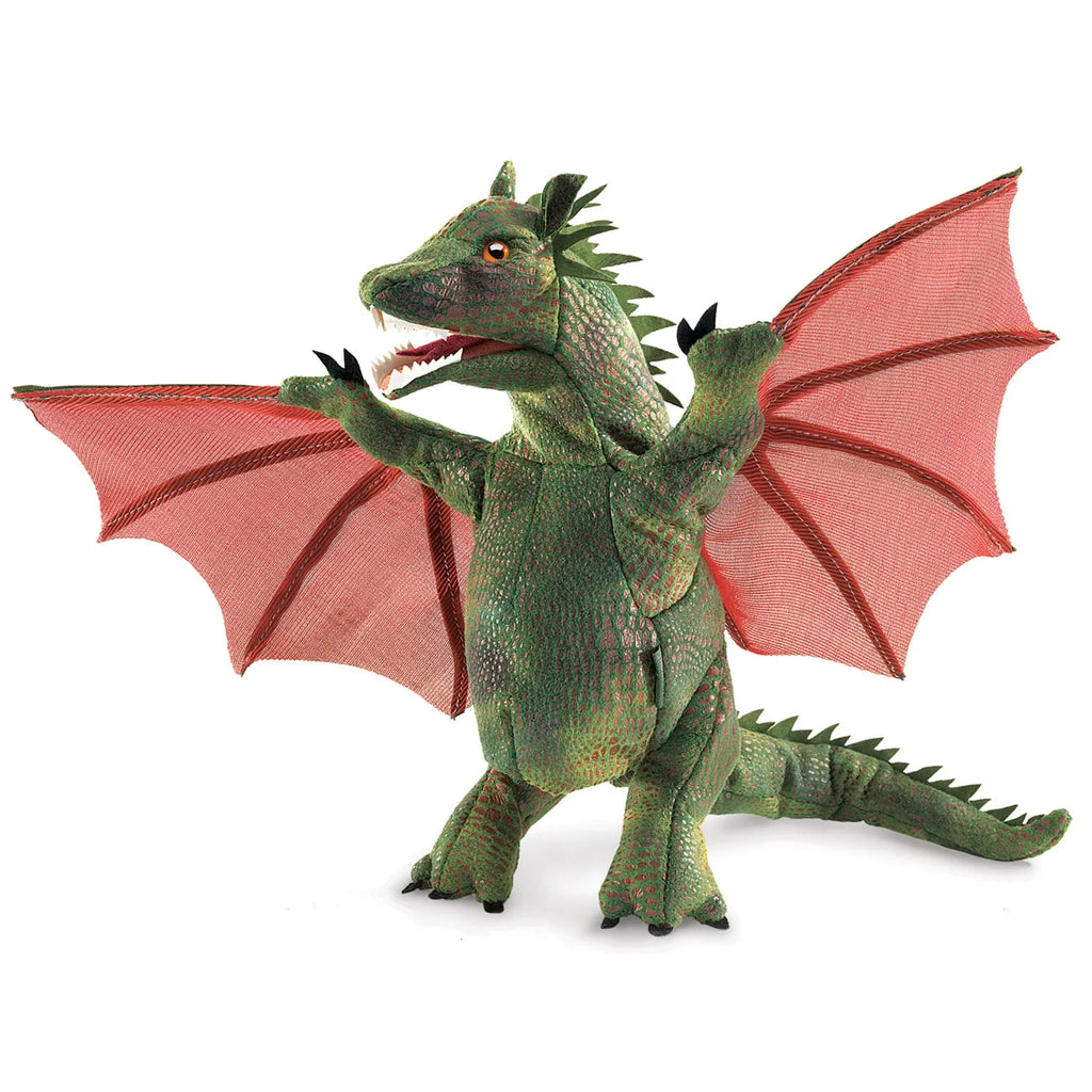 A green toy dragon with textured scales stands upright, wings spread wide. Its red, translucent wings and open mouth convey a playful, mythical vibe.