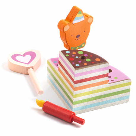 Wooden birthday cake toy with rainbow layers, candle, heart wand, and bear topper for toddler pretend play.