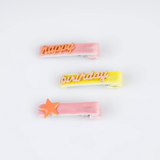 Three colorful velvet hair clips featuring text and a star charm.