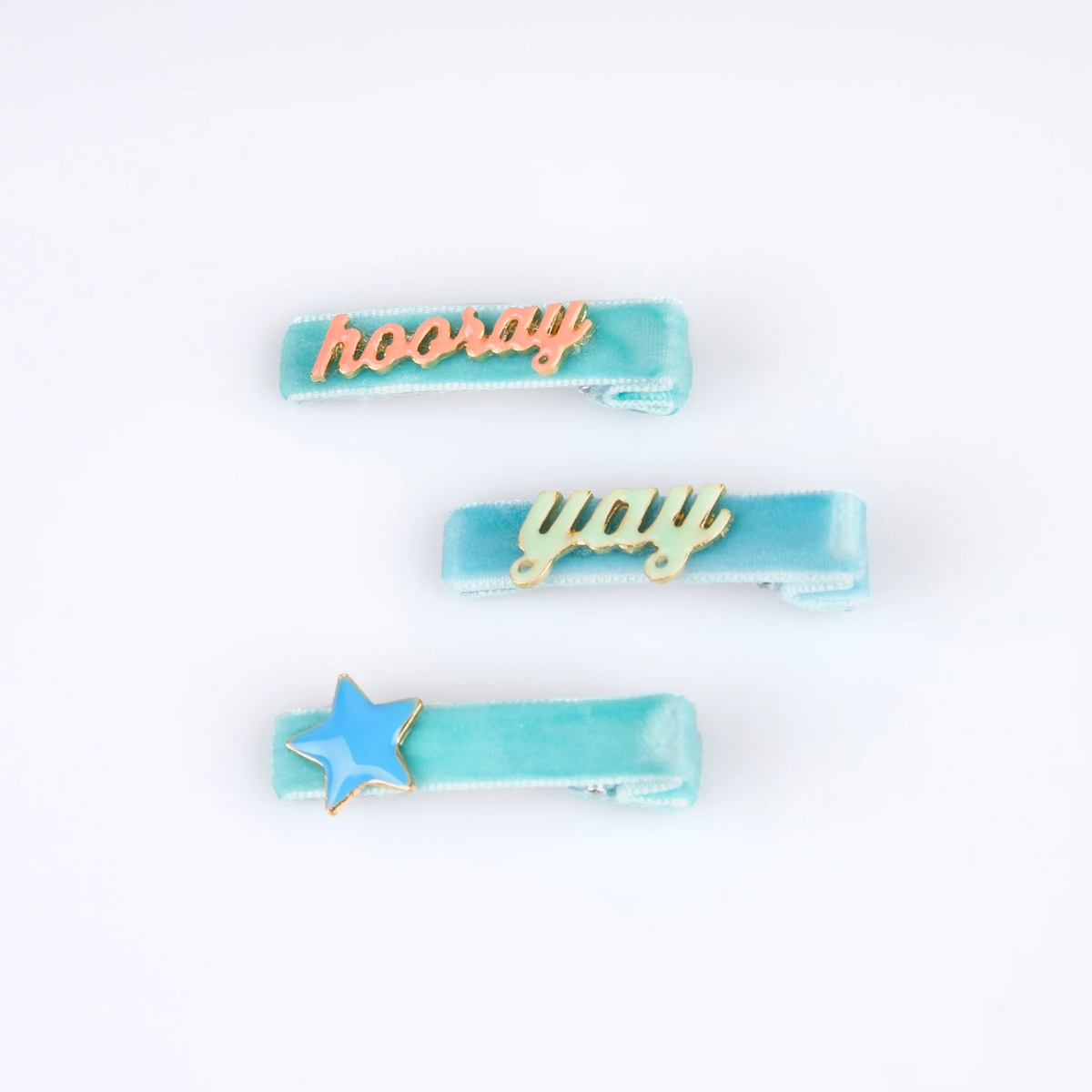 Three blue velvet hair clips with text and a star charm.