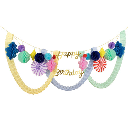 Festive party garland featuring gold script "Happy Birthday" text, colorful paper honeycomb balls, and tissue streamers.