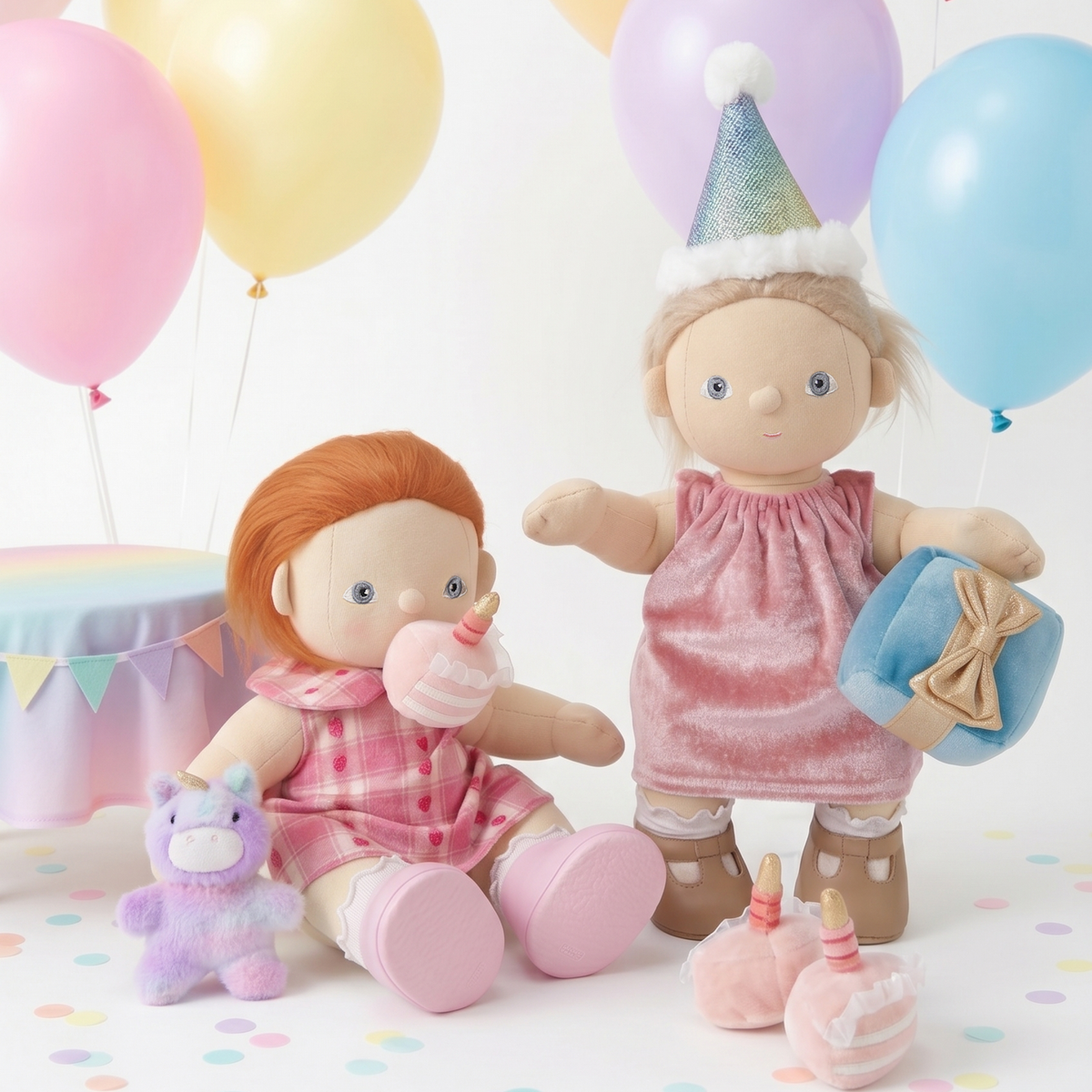 Two Olli Ella Dinkum Dolls celebrating a birthday party with pastel balloons and plush toys.
