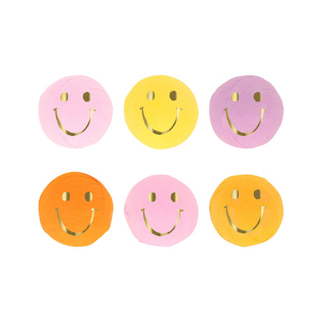 Six pastel crepe paper surprise balls with gold foil smiley faces arranged in two neat rows of three.