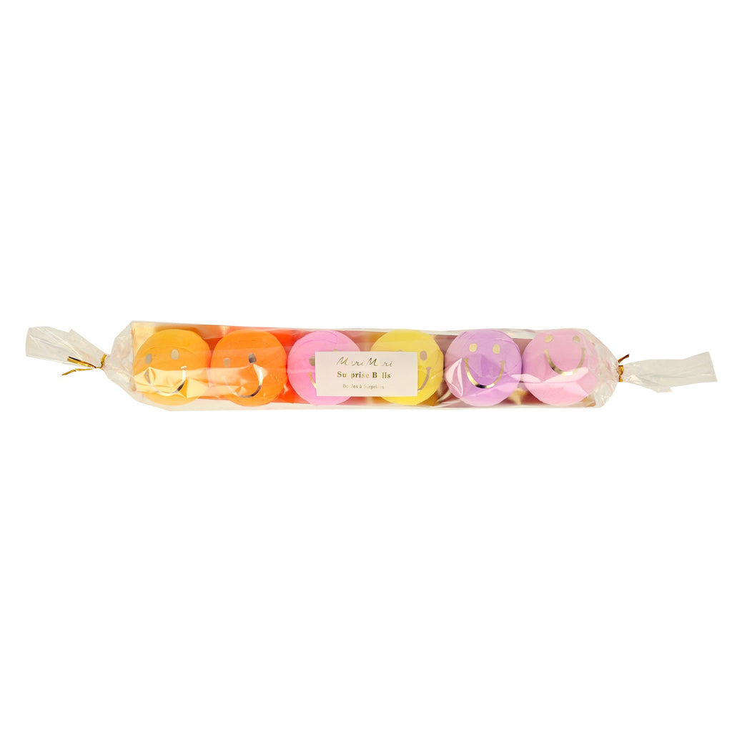 A set of colorful surprise balls featuring cheerful smiley face designs, filled with party favors or small treats.