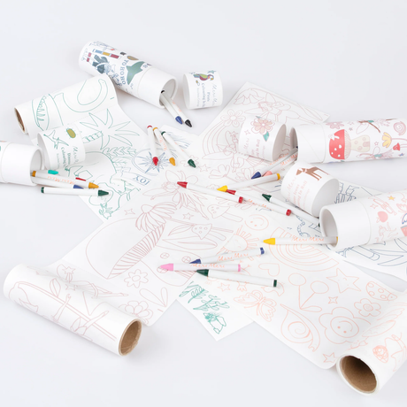 Unrolled coloring paper rolls scattered with crayons and packaging tubes on a plain white surface.