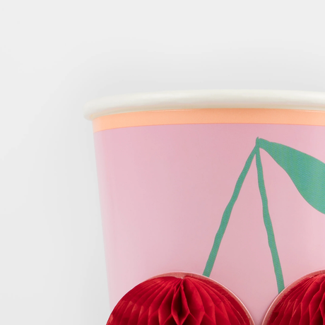 Close-up of a pink Meri Meri party cup highlighting the texture of the 3D red honeycomb cherry design.