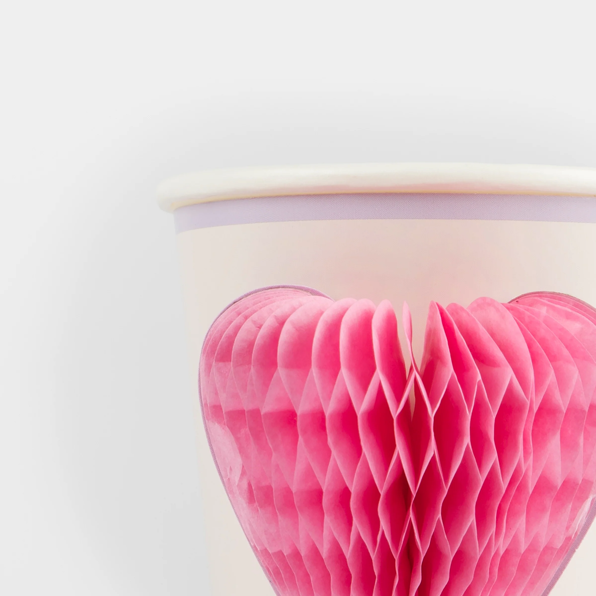 Close-up of a Meri Meri party cup highlighting the texture and detail of the 3D pink honeycomb heart design.