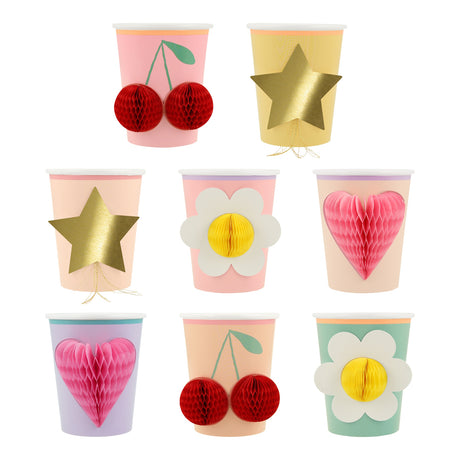 Meri Meri paper party cups featuring colorful designs with 3D honeycomb details like cherries, flowers, hearts, and gold stars.
