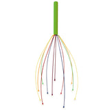 A green-handled head massager with colorful, flexible metal prongs splayed out. The prongs are red, blue, yellow, and orange, conveying a playful tone.