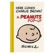 Cover of Peanuts pop-up book "Here Comes Charlie Brown!" by Schulz featuring a close-up of Charlie Brown's smiling face.