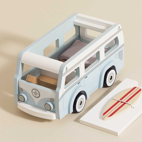 Light blue wooden toy camper van with removable roof board and striped surfboard.