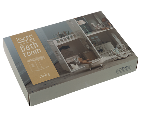 A minimalist dollhouse bathroom with two small windows and curtains, featuring a decorated tiled floor.