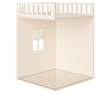 A minimalist dollhouse bathroom with two small windows and curtains, featuring a decorated tiled floor.