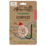 Huckleberry by Kikkerland kids wooden compass on kraft cardboard outdoor navigation toy packaging.